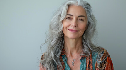 Beautiful woman with grey hair smiling posing on grey background. - obrazy, fototapety, plakaty