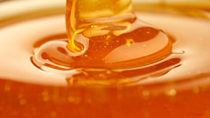 Pouring honey, flowing liquid sugar syrup. Thick Honey Dripping close up