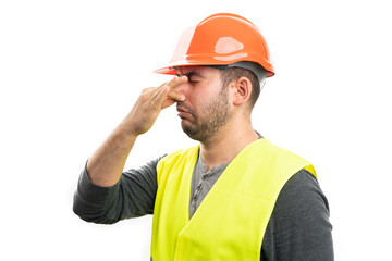 Builder man making grossed expression holding nose as bad smell