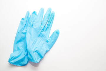 Hands wearing blue medical surgical gloves