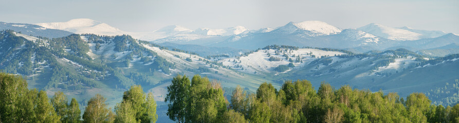 Snow in the mountains in early spring, panoramic view