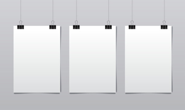 Set of three vertical white sheets of paper hanging on binder clips over gray wall. Realistic vector illustration