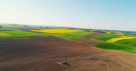 AGRICULTURE. Drone view of Agricultural tractor spraying field.