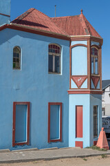 edge turret of picturesque old clear blue building at historical town, Luderitz,  Namibia