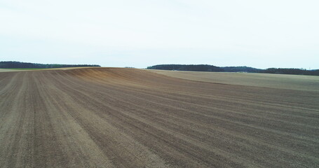 Fototapeta na wymiar Aerial of tractor harvesting field.