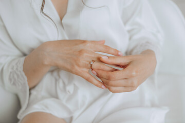 tender hands of a young woman with an expensive ring and a beautiful manicure. Close-up photo of female hands