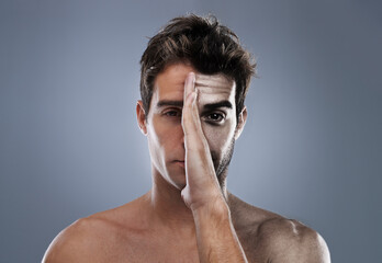 Man, hand and half face or shave for hair removal on grey background for transformation, comparison...