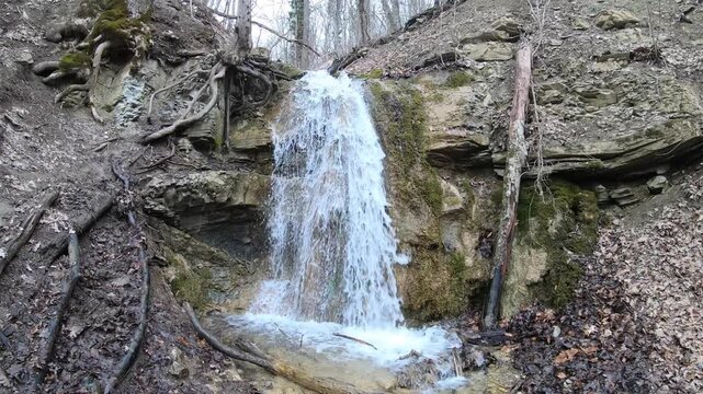 A big stormy waterfall in the spring forest.