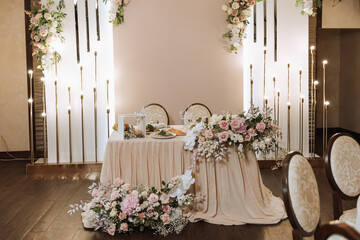 Restaurant wedding table for bride and groom. luxury wedding table with beautiful flowers. pink stylized