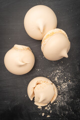 French meringue cookies on slate background. Top view with copy space