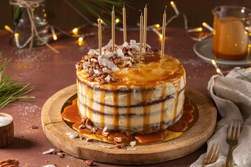 Delicious caramel cake with pecan nuts and coconut flakes
