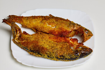 Trout prepared in the oven on a plate ready to be eaten.