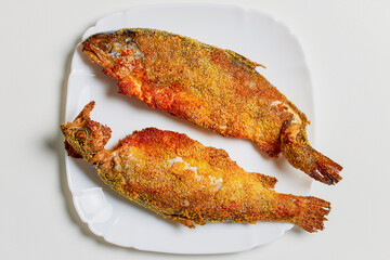 Trout prepared in the oven on a plate ready to be eaten.