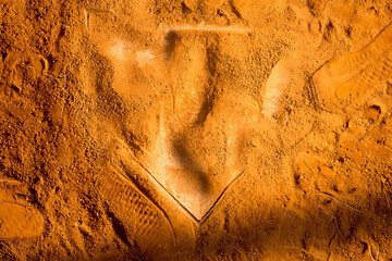red clay baseball field and various views of the baseball home plate