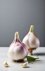 Three garlic bulbs, delicately arranged on a white table. 