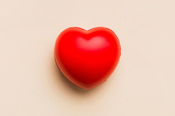 red heart shape on colored background. minimal concept top view with copy space