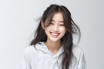 Asian girl with perfect skin and long, luxurious hair poses against a white backdrop, epitomizing beauty and simplicity. Generative AI.