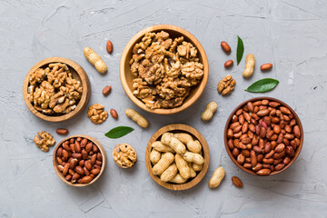 Walnut kernel halves, in a wooden bowl. Close-up, from above on colored background. Healthy eating Walnut concept. Super foods with copy space