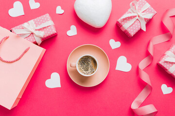 Mug coffee and gift box on colored background. Flat lay composition. Holiday concept