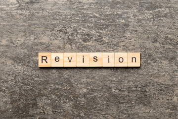 revision word written on wood block. revision text on table, concept