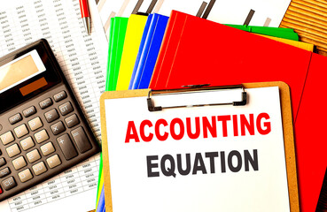 ACCOUNTING EQUATION text written on paper clipboard with chart and calculator