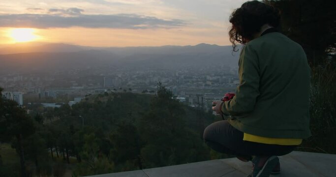 Girl taking pictures of city landscape