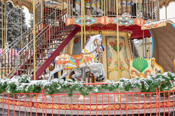 Wooden horse on the fairground. Children's carousel