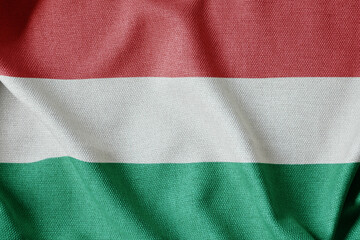 National flag of Hungary flutters in the wind. Wavy Flag. Close-up front view.

