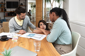 Group of young business people interior and exterior designers architects of prefab ecological houses working at home office on a project of energy efficient housing. Architectural engineers work