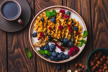 Waffles with berries and chocolate sauce