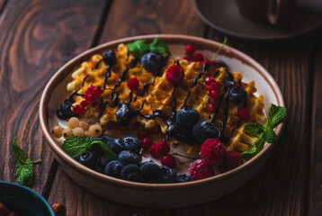 Waffles with berries and chocolate sauce