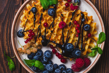 Waffles with berries and chocolate sauce