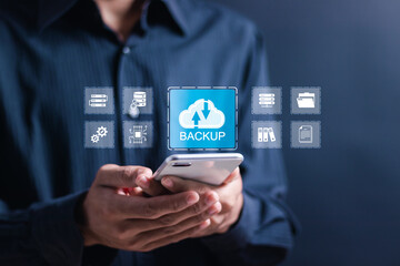 Backup storage data technology concept. Person use smartphone with virtual backup icons for backup online documentation database and digital file storage system or software,file access, doc sharing.