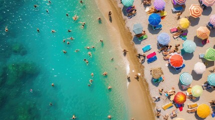 A vibrant beach scene from above, packed with people and a wide array of colorful umbrellas.