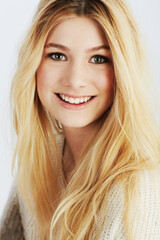 Naklejka premium Beauty, portrait and smile with natural woman closeup in studio on white background for wellness. Face, skincare or aesthetic and happy young blonde model looking satisfied with cosmetic routine