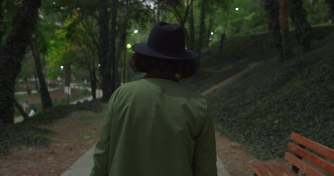 Girl in a hat walking in a park