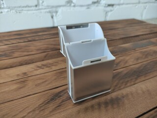 Modern metal cigarette case on wooden background