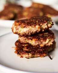 Beef, zucchini and cheddar cheese patties or cutlets on white plate. Dinner meat concept, full of proteins. 