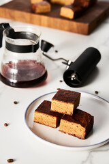 Sweet Breakfast concept. Blondies bars with v60 filter coffee, light background, airy mood food photo