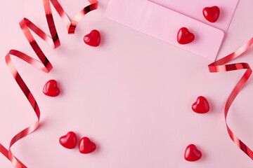 Valentine's day card on a pink background viewed from above. Copy space. Top view