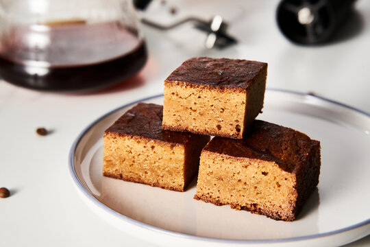 Sweet Breakfast concept. Blondies bars with v60 filter coffee, light background, airy mood food photo