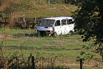 Old van, broken down, abandoned in the field.