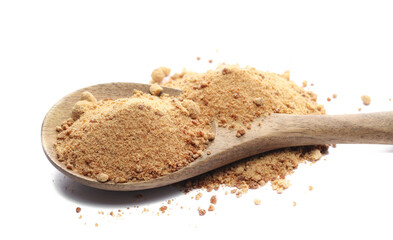 Unrefined brown cane sugar pile in wooden spoon isolated on white