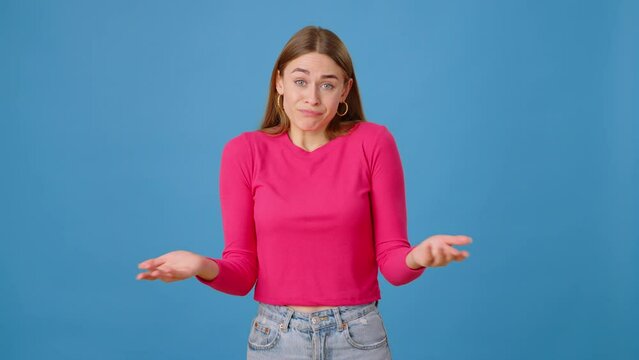 Indecisive female connecting fingers and shrugging in studio