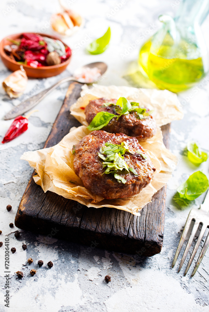 Canvas Prints Tasty grilled hamburger patties with seasonings on wooden board