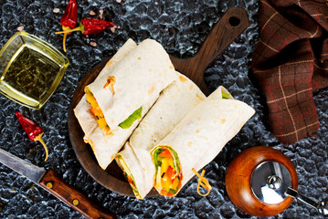 Salmon and cream cheese wraps. Rolls with smoked salmon, basil and rocket salad. Burrito on serving board - 720306616