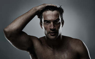 Portrait, man and water with dermatology, sweating and morning routine on a grey studio background....
