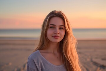 Portrait on the beach young woman with long blond hair