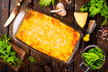Rectangular glass bowl filled with mashed potato, underneath which is fish in cheese sauce. - 720308299