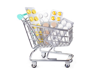 Medical shopping concept: shopping cart with pills on white background
